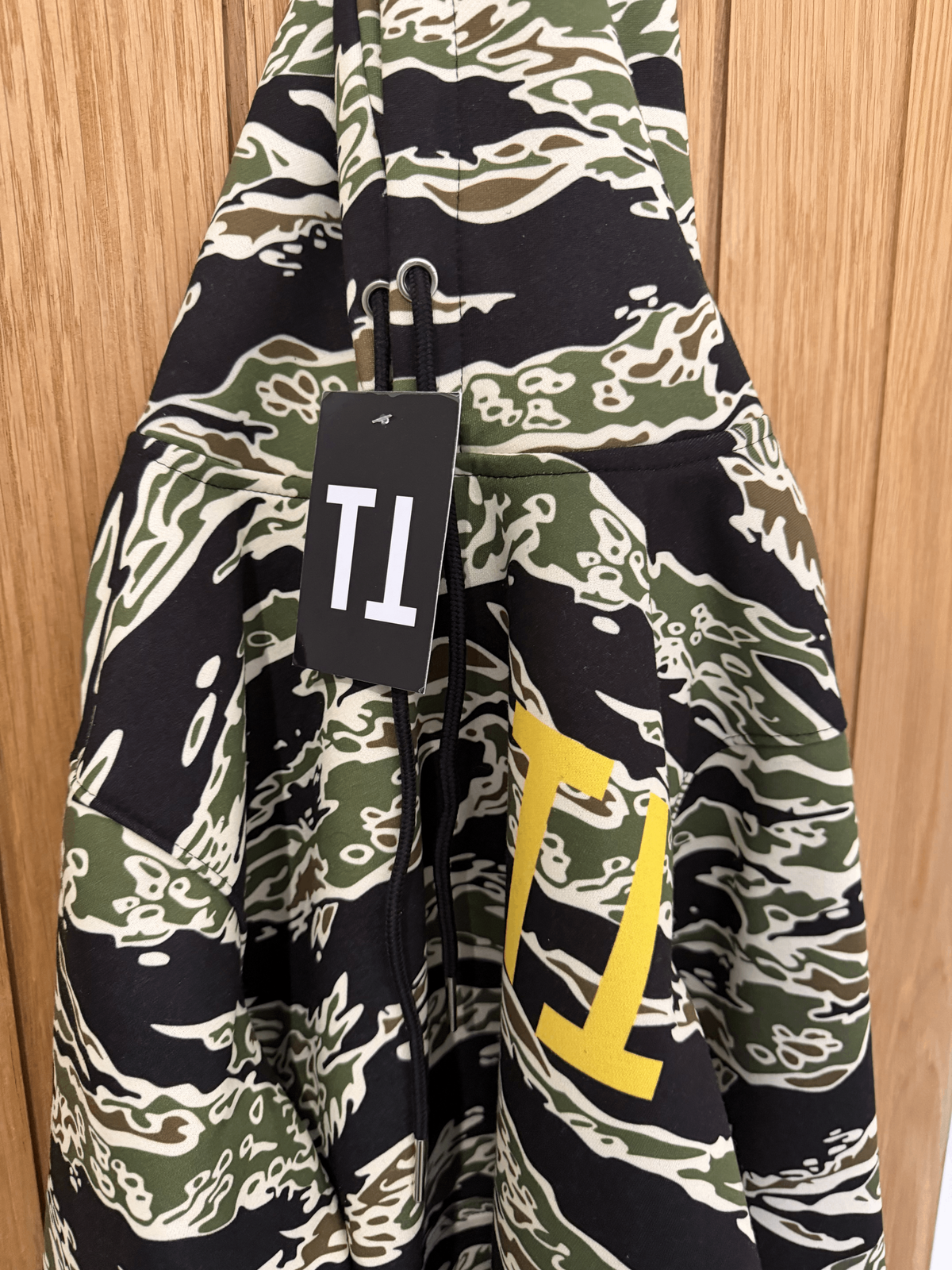 Tiger Camo Yellow Shark Hoodie, hanging flat lay view